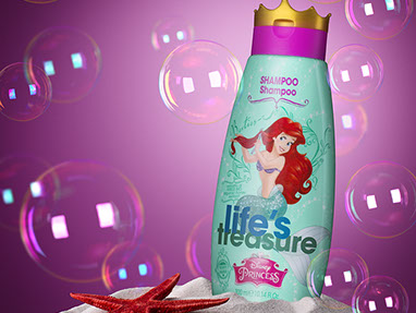 The bottle of shampoo for girls placed in the sand. Red starfish on the left. Soap bubbles around. Dark pink background.