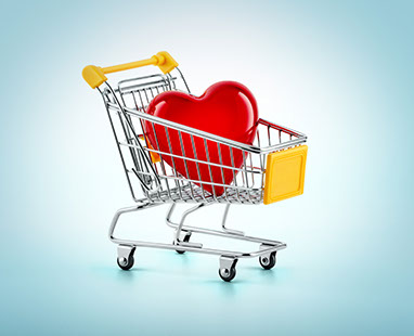 A shopping cart with a red heart inside. Light blue background. The climate sad and pensive. Horizontal.