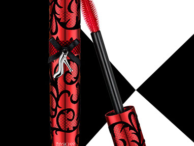 Red Mascara with blacks velvety details and the small metal shoe charm. White and black background created with the mirror and its reflection.